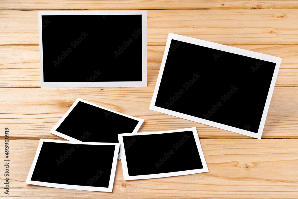Blank photo frames for your photos on wooden background Blank photo frames for your photos on wooden background