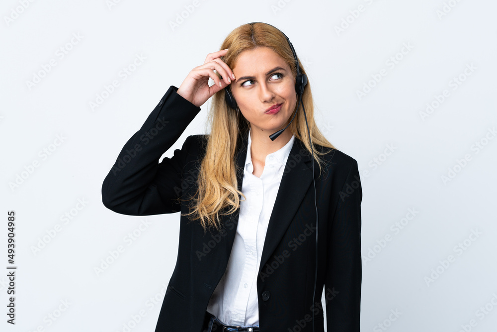 Young telemarketer woman over isolated white background having doubts and with confuse face expression