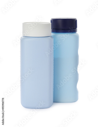 Bottles of dusting powder on white background, space for design. Baby cosmetic product