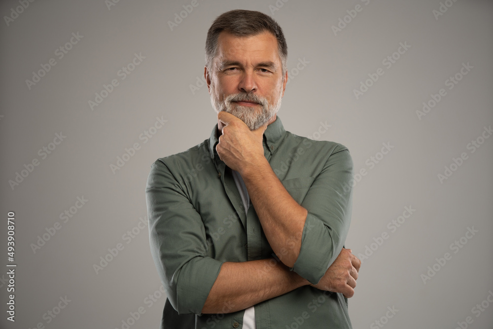 Portrait of smiling mature man standing on white background Portrait of smiling mature man standing on white background
