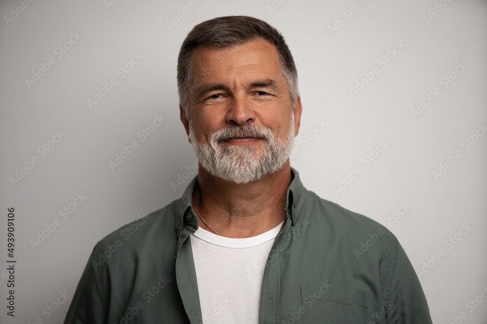 Portrait of smiling mature man standing on white background Portrait of smiling mature man standing on white background