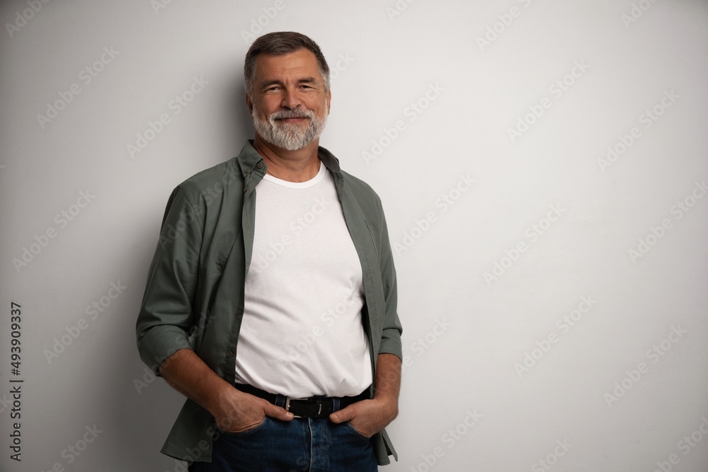 Portrait of smiling mature man standing on white background Portrait of smiling mature man standing on white background