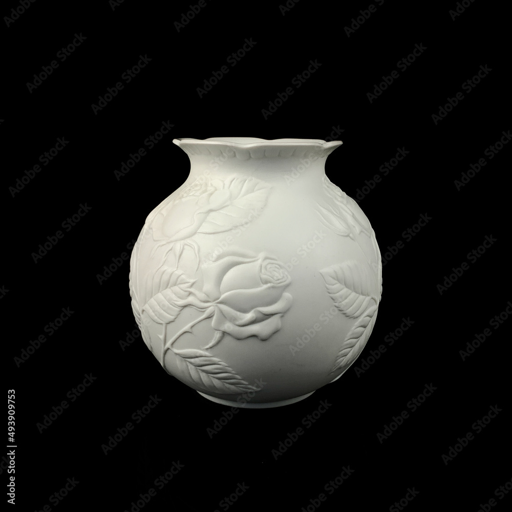 antique white porcelain vase in on a black isolated background. antique ceramic vase with stucco antique white porcelain vase in on a black isolated background. antique ceramic vase with stucco