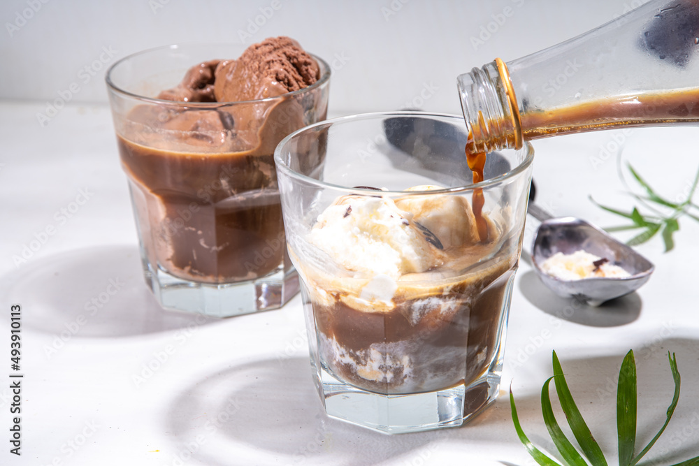 Summer cold cocktail. Amaro floats with chocolate and vanilla ice cream. Affogato Coffee latte with ice cream drink. Copy space on a white table Summer cold cocktail. Amaro floats with chocolate and vanilla ice cream. Affogato Coffee latte with ice cream drink. Copy space on a white table