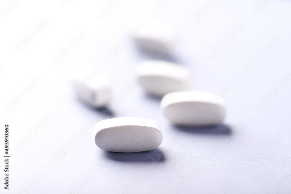 Lysine tablets. Concept for a healthy dietary supplementation. Nervous System Support. Soft focus. Bright background. Close up. Copy space. Lysine tablets. Concept for a healthy dietary supplementation. Nervous System Support. Soft focus. Bright background. Close up. Copy space.