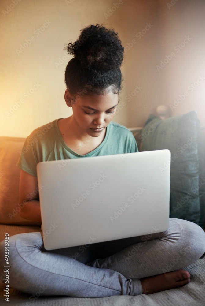 Going through some online study material. Cropped shot of a young female student studying at home. Going through some online study material. Cropped shot of a young female student studying at home.