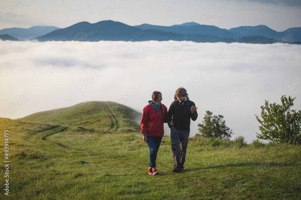Young Couple in Love Walks in Amazing Carpathian Misty Mountain Scenery Young Couple in Love Walks in Amazing Carpathian Misty Mountain Scenery