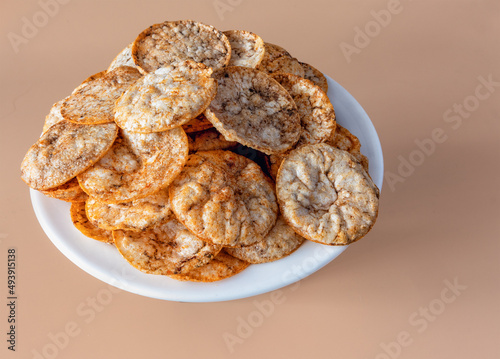 Brown rice chips on a white plate photo