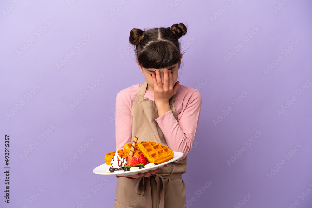 Little caucasian girl holding waffles isolated on purple background with tired and sick expression Little caucasian girl holding waffles isolated on purple background with tired and sick expression