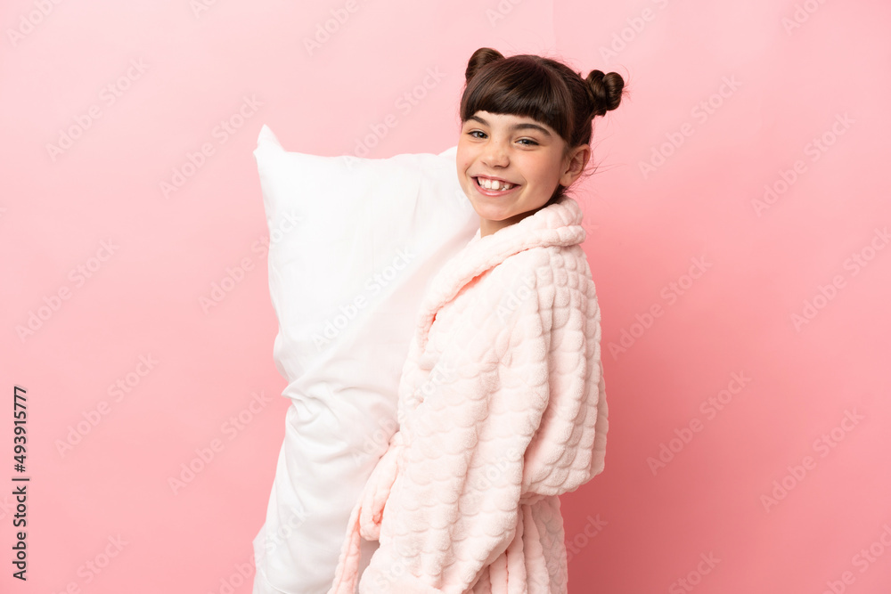 Little caucasian girl isolated on pink background in pajamas and smiling a lot Little caucasian girl isolated on pink background in pajamas and smiling a lot