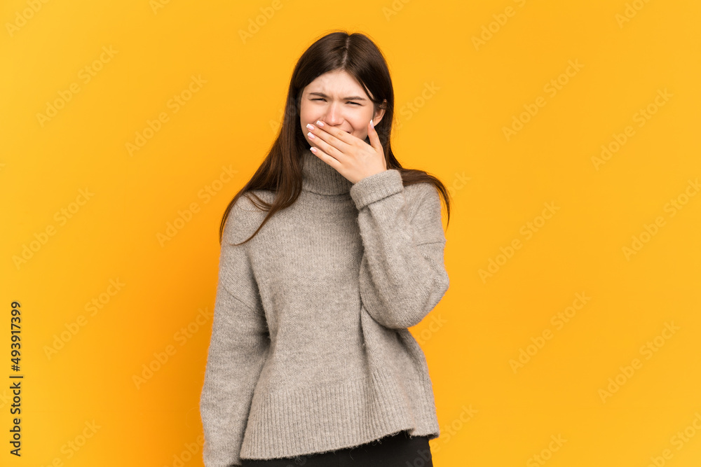 Young Ukrainian girl isolated on yellow background happy and smiling covering mouth with hand Young Ukrainian girl isolated on yellow background happy and smiling covering mouth with hand