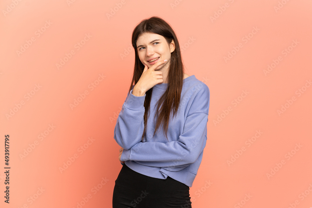 Young Ukrainian girl isolated on pink background looking to the side and smiling Young Ukrainian girl isolated on pink background looking to the side and smiling