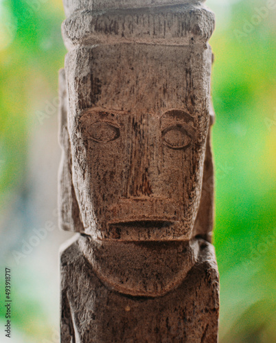 Old wooden god idol in Bali. Religious sculpture totem