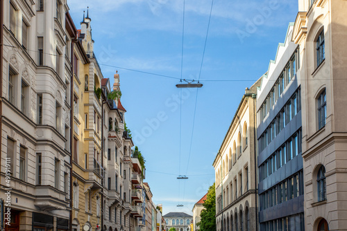 Germany, Bavaria, Munich, Power lines hanging between rows of townhouses photo