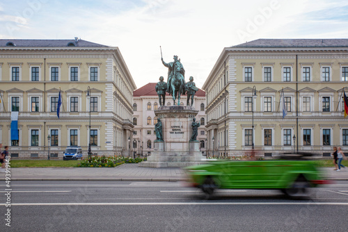 Germany, Bavaria, Munich, Car passing statue of Ludwig I of Bavaria standing in front of Bavarian State Ministry of Finance and Home photo