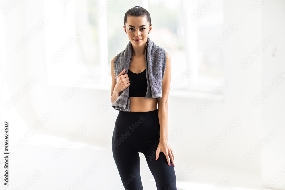 Portrait of a happy fitness woman with towel isolated on a white background Portrait of a happy fitness woman with towel isolated on a white background