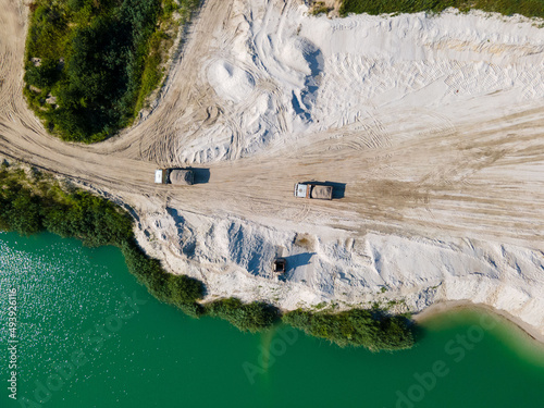 heavy industry overhead view of excavator at sand quarry photo