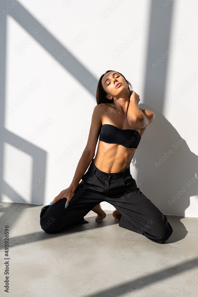 Sexy slim woman wearing black suit with black bra is sexy dark tone fashion posing studio shot Sexy slim woman wearing black suit with black bra is sexy dark tone fashion posing studio shot