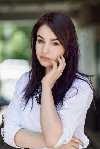 Summer portrait of beautiful young woman with dark hair.