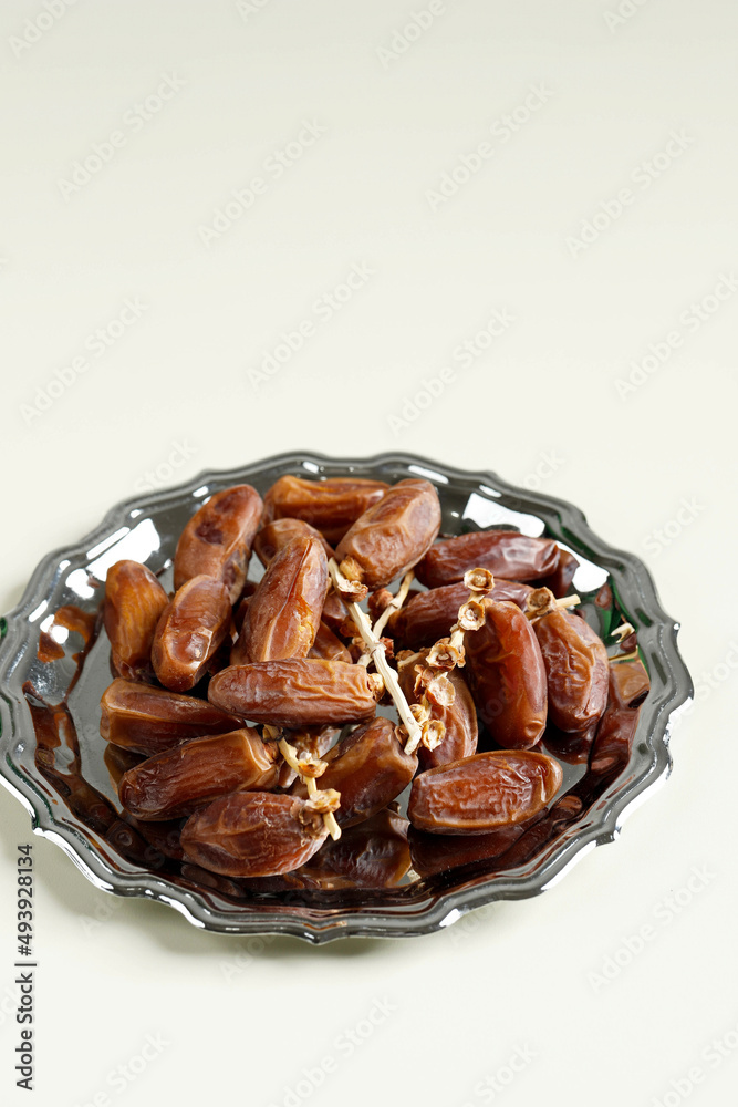 Tunisian Dates or Kurma Tunisia isolated on Cream Background for Breaking the Fast or Buka Puasa.