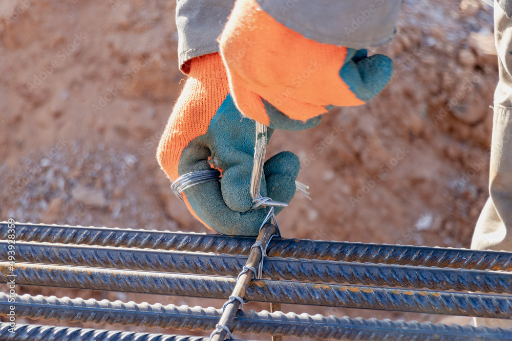 A Worker Uses Steel Tying Wire To Fasten Steel Rods To Reinforcement A Worker Uses Steel Tying Wire To Fasten Steel Rods To Reinforcement