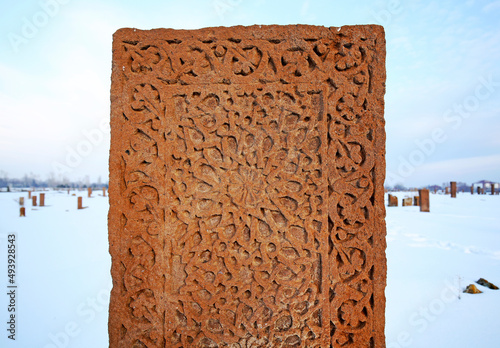 Historical Ahlat Seljuk Square Cemetery with islamic tombstones during winter under snow