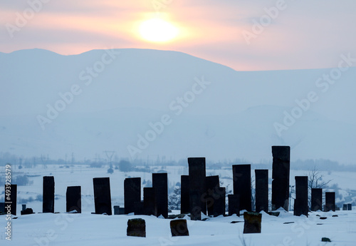 Historical Ahlat Seljuk Square Cemetery with islamic tombstones during winter under snow