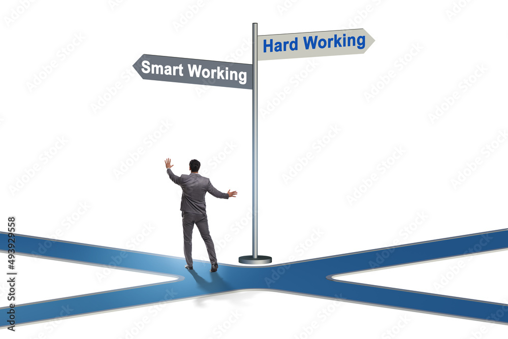Businessman at the crossroads on working smart or hard Businessman at the crossroads on working smart or hard