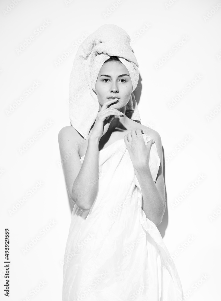 black and white portrait on a white background of a girl in a towel black and white portrait on a white background of a girl in a towel