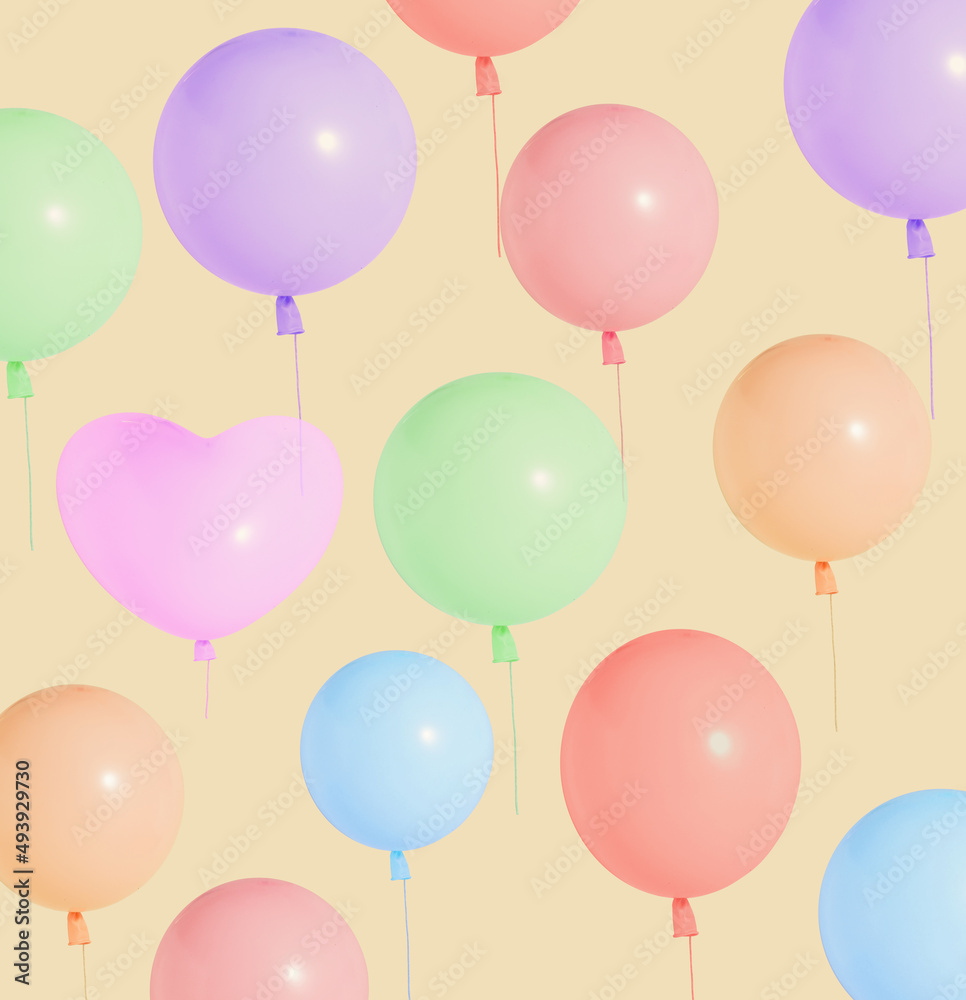 Creative layout of colored balloon on beige background. Minimal concept, pattern.