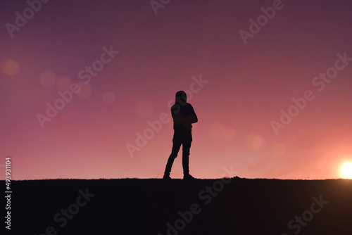 man silhouette trekking in the mountain with a beautiful sunset