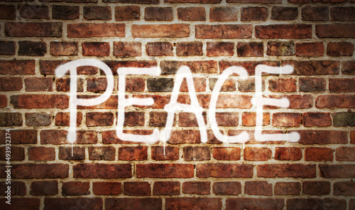 Peace spray painted on the brick wall