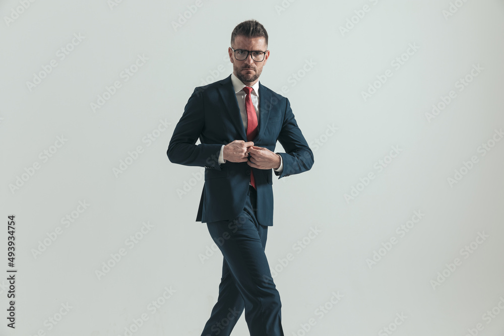 frowning businessman with eyeglasses unbuttoning suit and walking frowning businessman with eyeglasses unbuttoning suit and walking