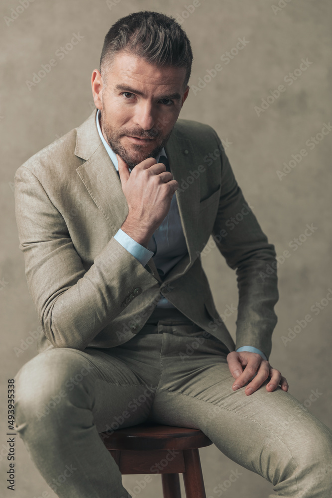 fashion model sitting on a chair, posing relaxed fashion model sitting on a chair, posing relaxed