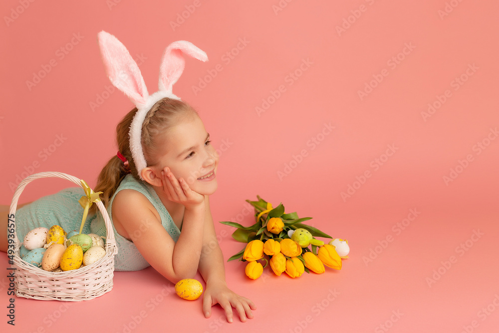 Closeup portrait of a smiling little girl on a pink background with an easter decor. Copy space. Happy easter Closeup portrait of a smiling little girl on a pink background with an easter decor. Copy space. Happy easter