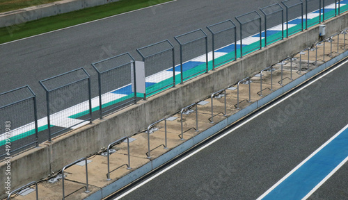 Asphalt racing track and steel fence.