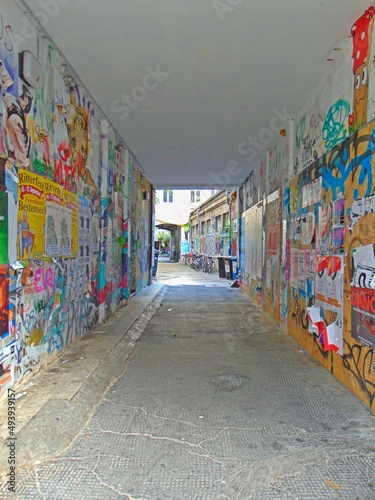 Posters and graffiti  covering an alleyway  © Michael