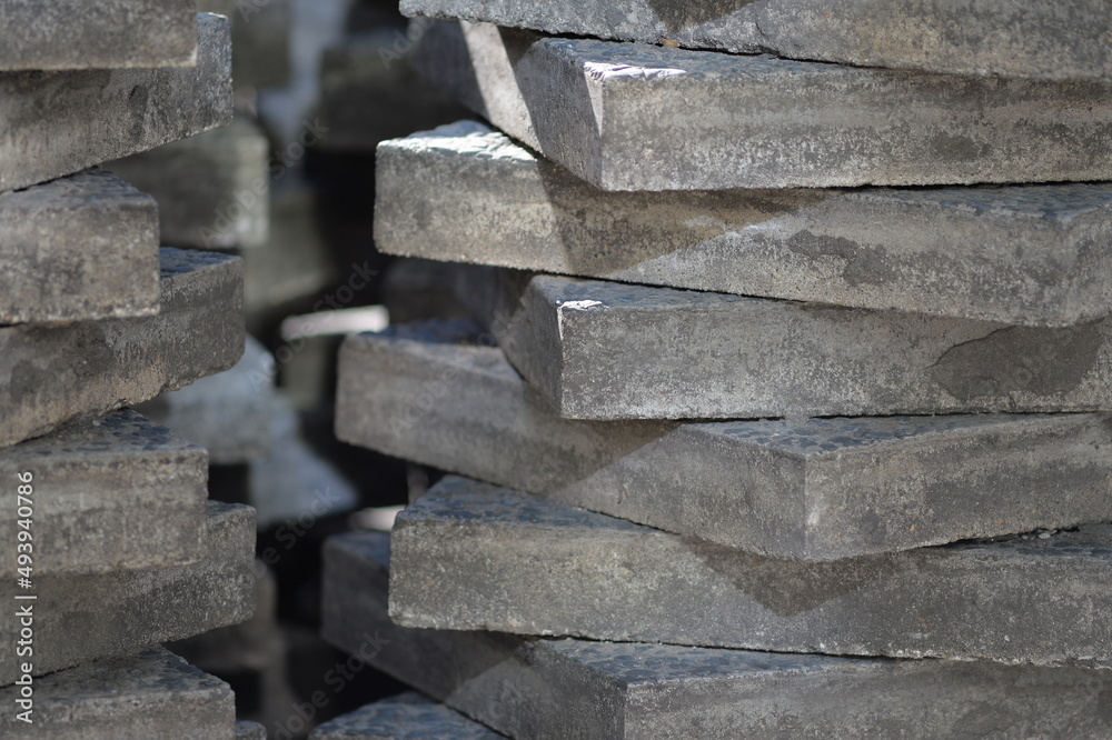 Stacked gray paving slabs in diagonal arrangement on construction site in Berlin-Germany. Stacked gray paving slabs in diagonal arrangement on construction site in Berlin-Germany.