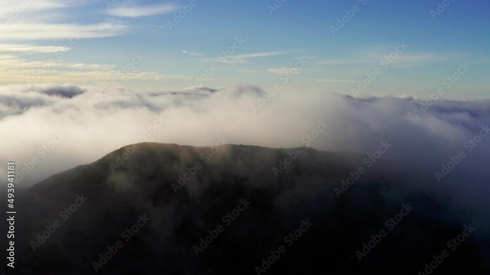 Obscure and spectacular aerial view of a mountain cloud inversion background Obscure and spectacular aerial view of a mountain cloud inversion background