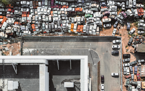 Aerial view of a Soviet automobile dump from a drone. Shooting from above at heaps of rusty cars. Abandoned Russian cars awaiting disposal and recycling photo