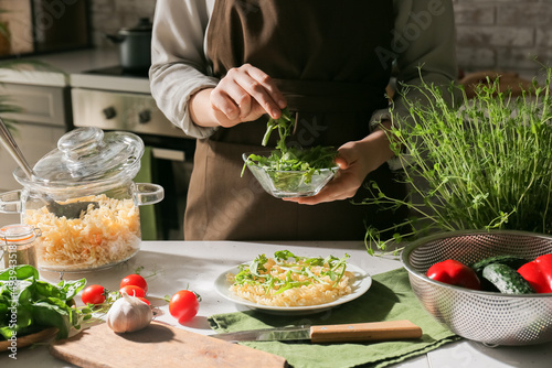 Fototapeta Naklejka Na Ścianę i Meble -  Woman preparing tasty pasta at table in kitchen
