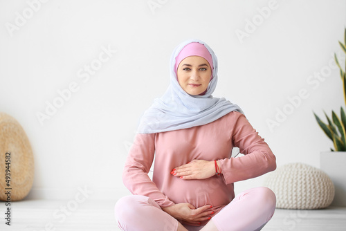 Young pregnant Muslim woman...