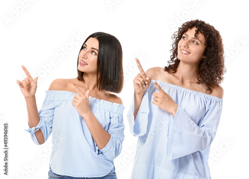 Young sisters pointing at s...