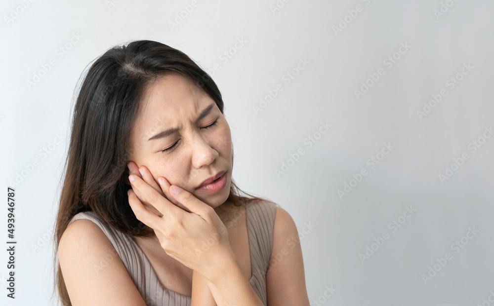 Asian woman feeling teeth pain. Closeup of sad girl suffering from toothache on white background. Dental health and care, teeth problem concept. Copy space, closeup Asian woman feeling teeth pain. Closeup of sad girl suffering from toothache on white background. Dental health and care, teeth problem concept. Copy space, closeup