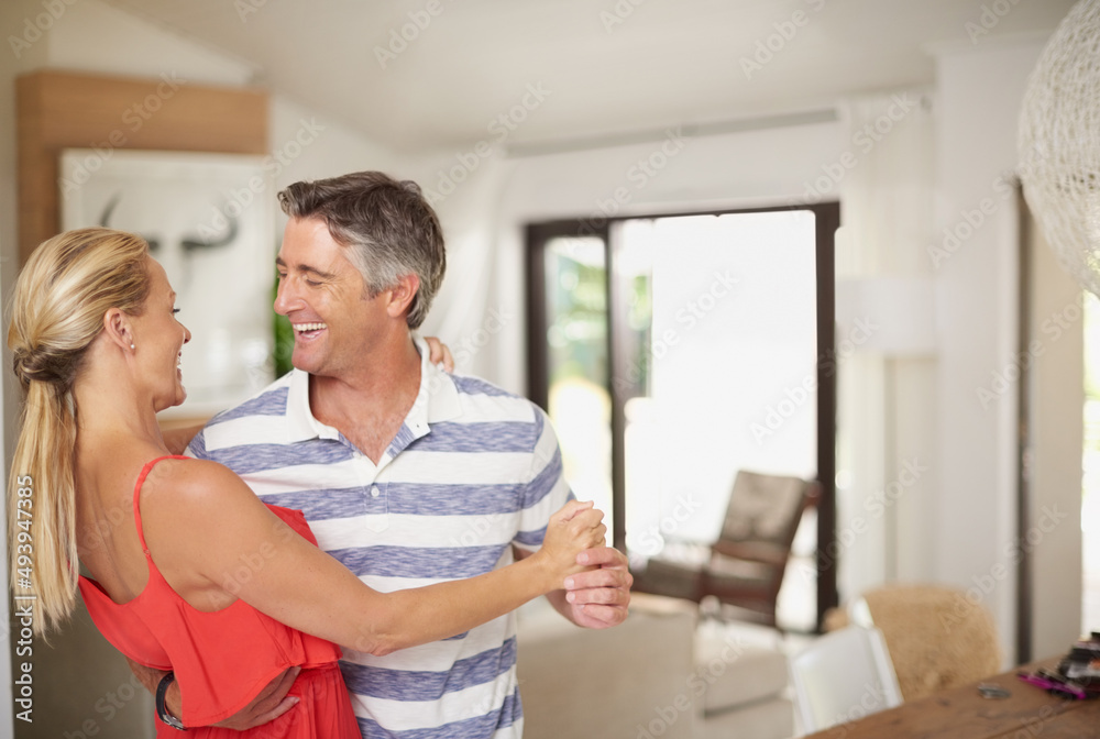 Obraz premium My eyes turn to hearts when I see you. Shot of a happily married couple dancing together at home.