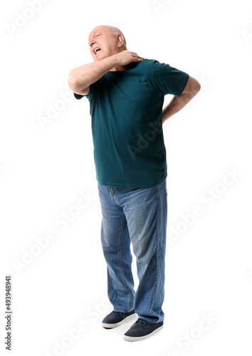 Senior man suffering from back pain on white background