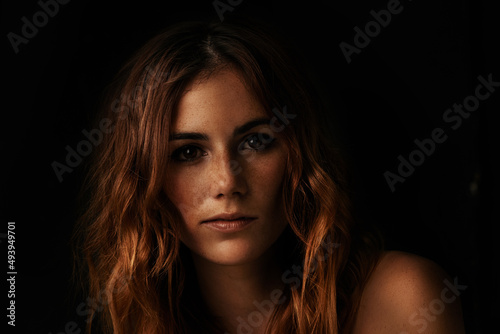 She can light up the darkness. Portrait of an attractive young woman in the dark.