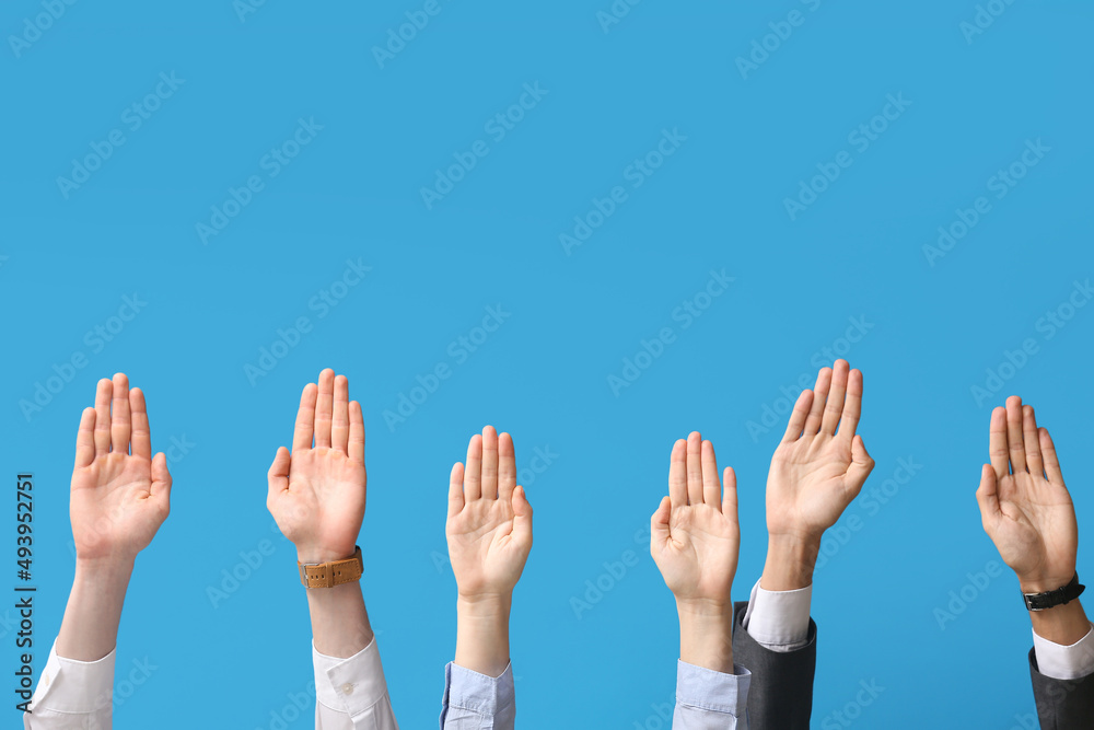 Business people showing stop gesture on blue background