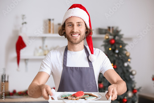 Young man in Santa hat hold...