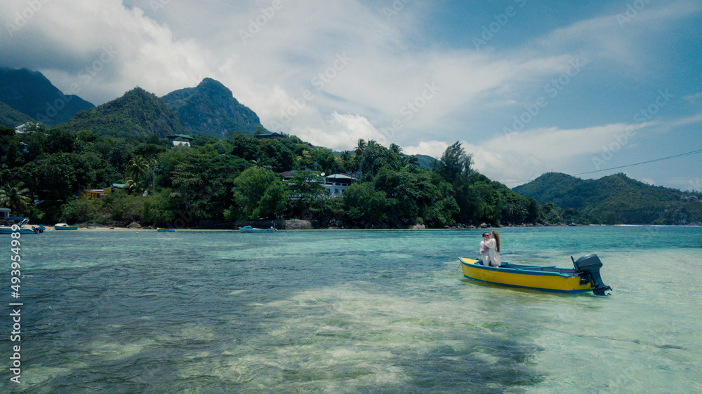 Two lovers in a boat in the Seychelles, in the middle of the Indian Ocean